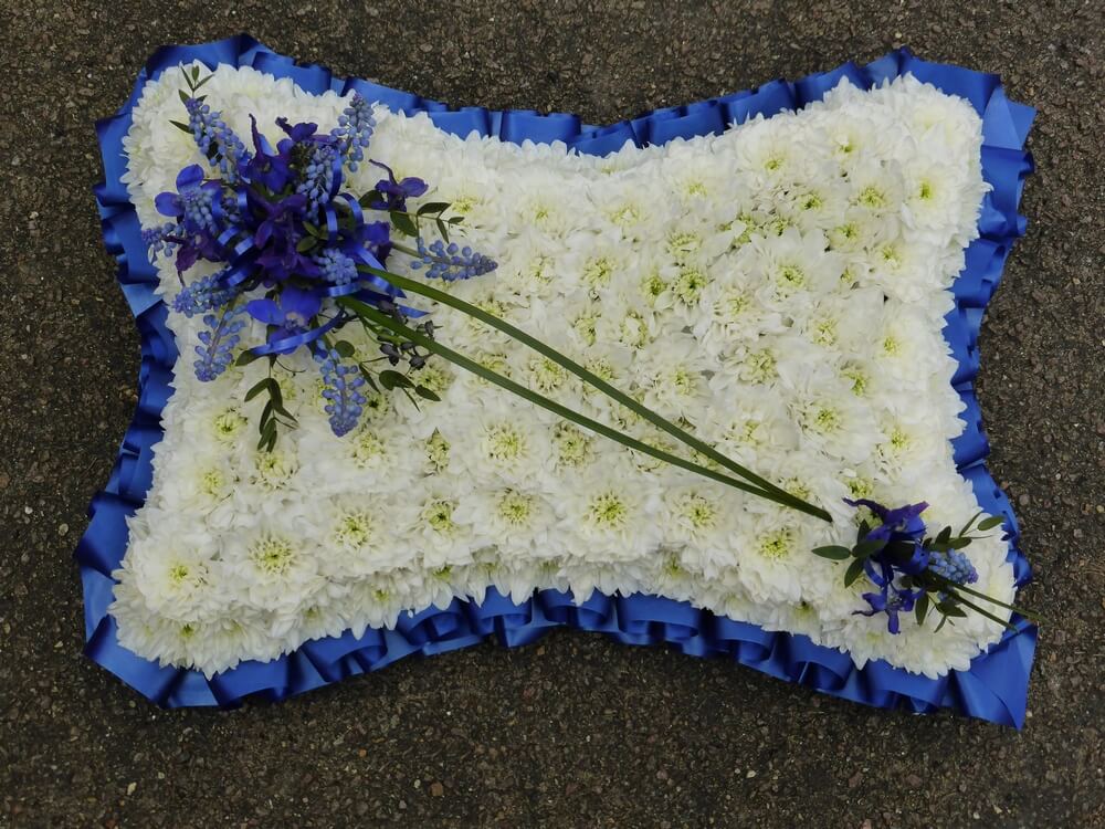 14. 18” white pillow with blue ribbon edge, blue Muscari and Delphinium posies