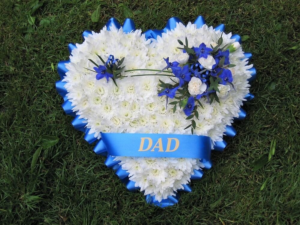 9.  White Heart with blue ribbon edge, ribbon sash, posy of Delphiniums and Dianthus