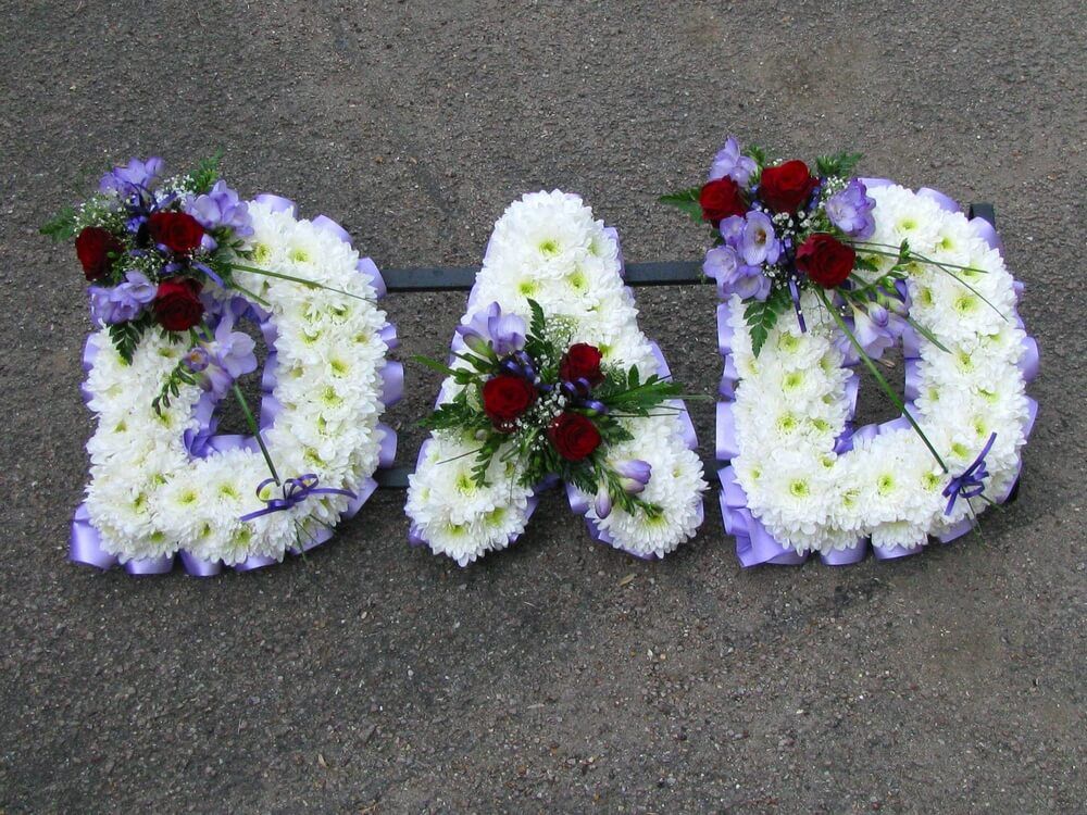 13. White letters with lilac Freesias and burgundy Roses
