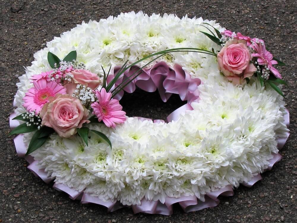 14.  12” wreath with white Chrysanthemums, pink Roses and Germini