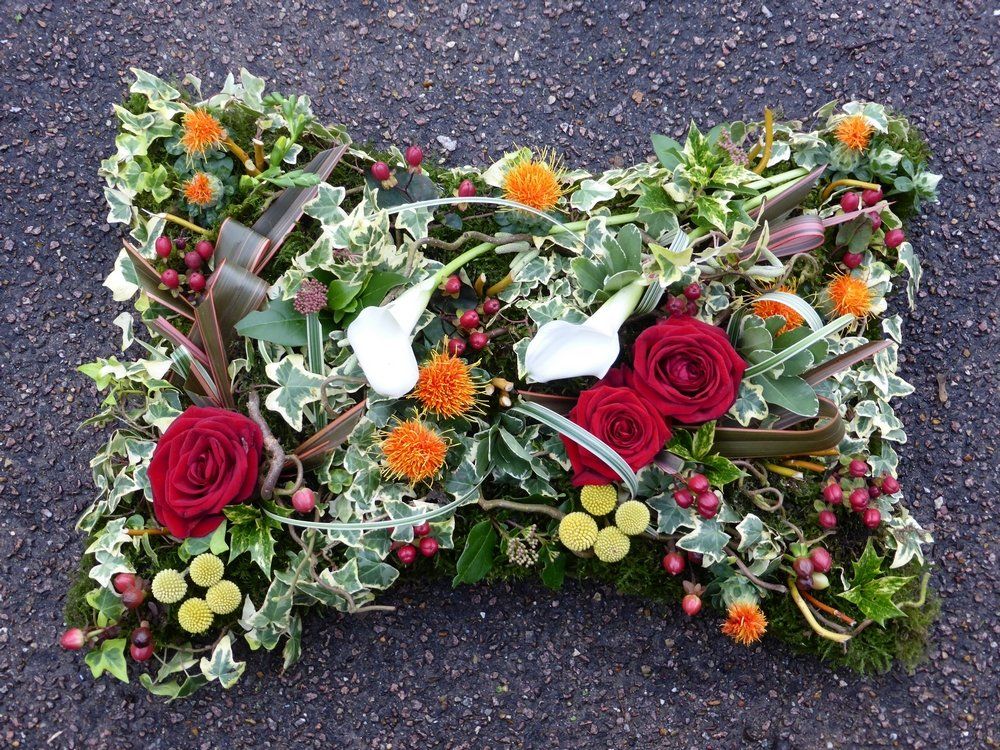 10. 18” Very natural pillow with Ivy, Roses, Craspedias, Callas, Berries, Thistles, Phormium foliage and Moss
