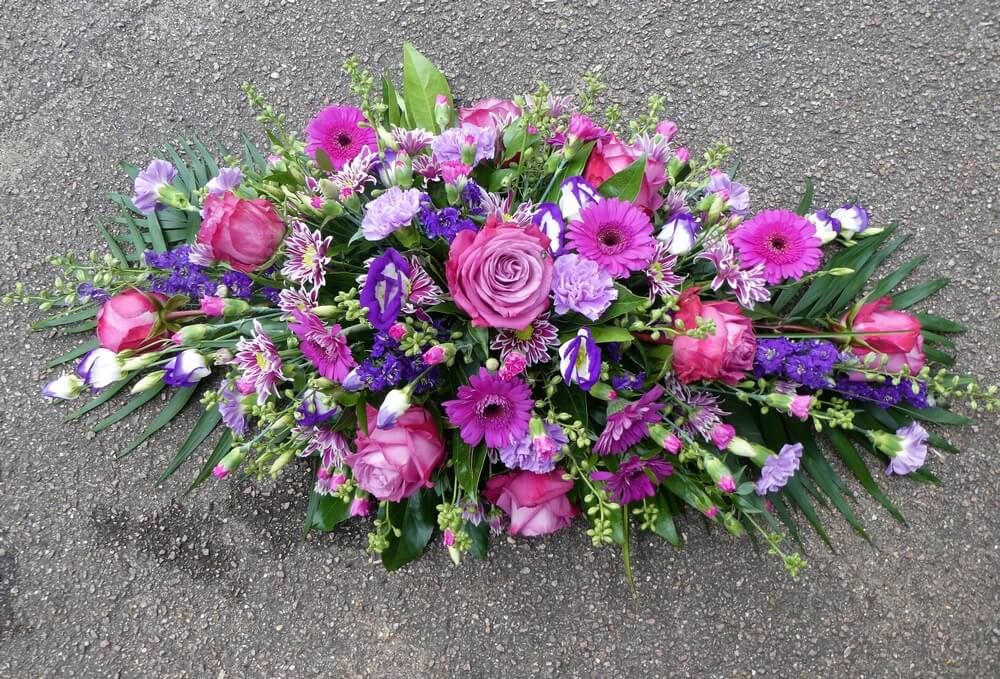 24. Colourful purple spray with Roses, Germinis, Larkspur, Carnations and Dianthus