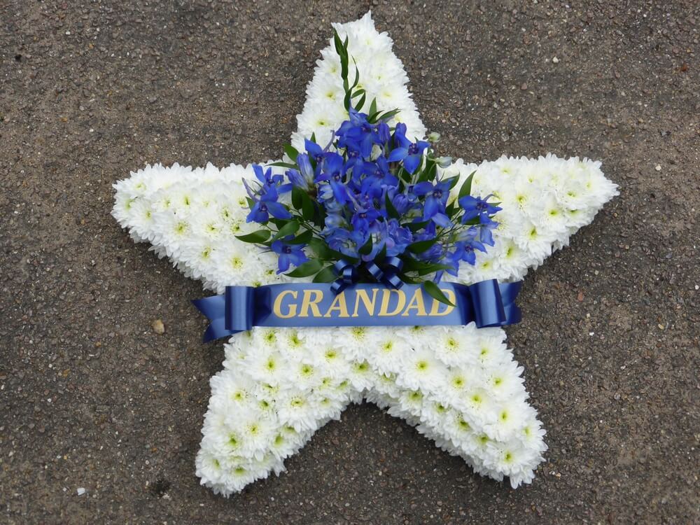 34. White 24” Star with ribbon sash and posy
