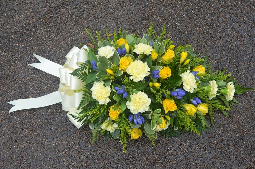 8.  Spray with yellow Roses, Freesia, Golden Rod, Carnations and Blue Gentianas