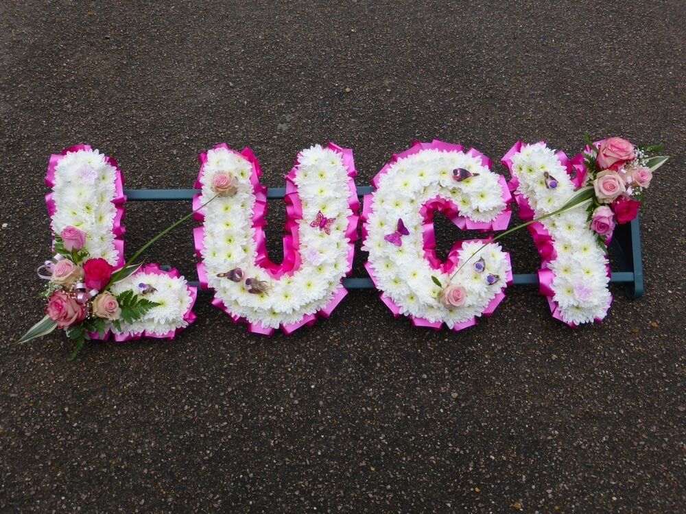 32. White letters with cerise ribbon edge, shades of pink Rose posies, tiny feather birds and butterflies