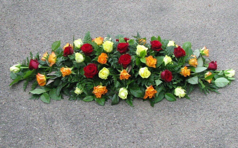 7.   Spray of Lemon, Orange and Red Roses