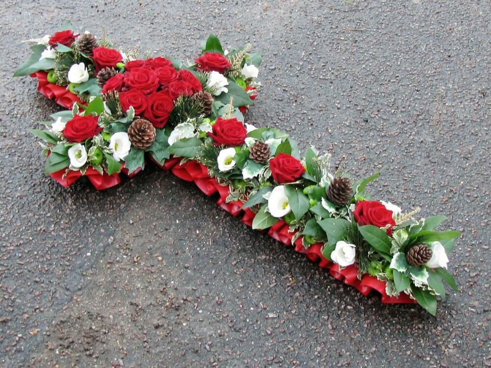 1.  4ft Cross with red ribbon edge, red Roses to the centre, white Lisianthus and foliage