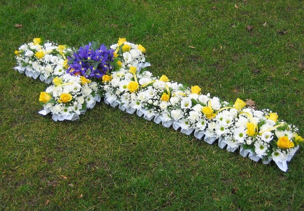 13. 4ft Cross in white and yellow with blue Iris posy to the centre