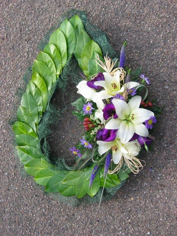 9.  Teardrop Chaplet with Laurel Leaves and posy of white Lilys, Berries,  purple Lisiathus and Veronicas