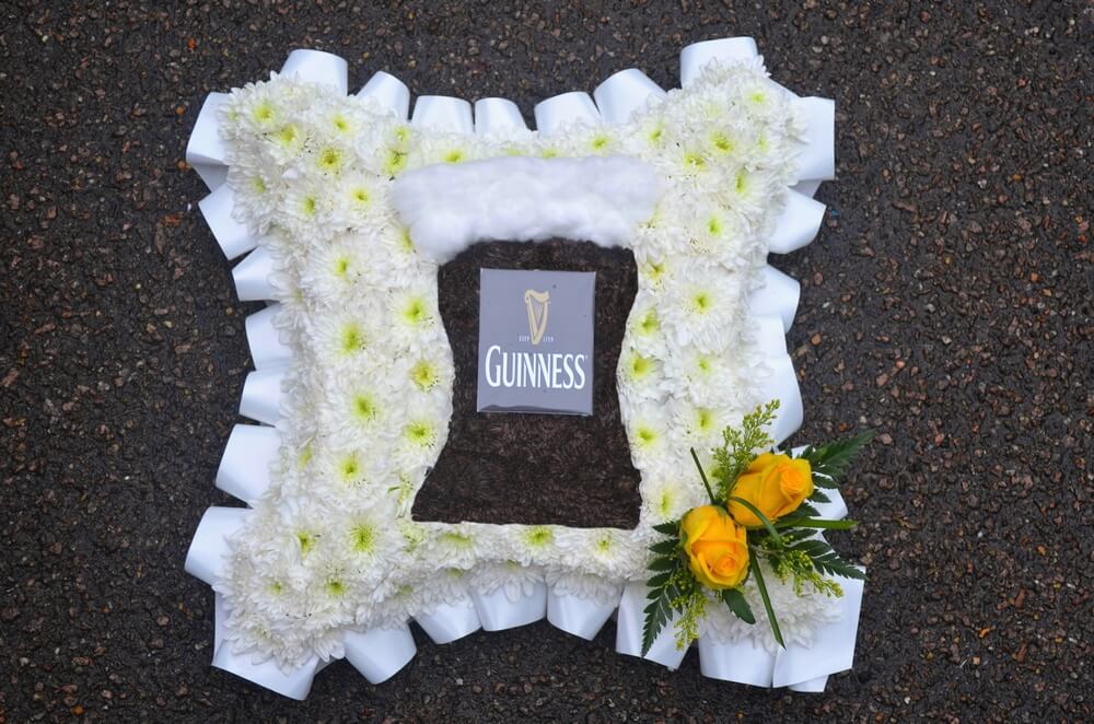 9.  12” white Cushion with custom made Guinness Glass to the centre, white ribbon edge and yellow Rose posy
