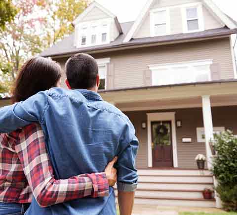 Homeowners Insurance — Rear View Of Loving Couple Looking At House in Manchester, NH Homeowners Insurance — Rear View Of Loving Couple Looking At House in Manchester, NH