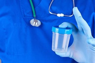 Doctor Holding an Empty Plastic Container — Omaha, NE — Arbor Heights Family Medicine Doctor Holding an Empty Plastic Container — Omaha, NE — Arbor Heights Family Medicine