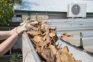 A home gutter that needs gutter cleaning in Maryville, IL