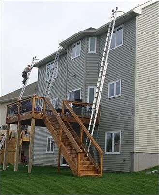 A House Being Serviced by Gutter Specialists — Gutter Specialist in Edwardsville, IL