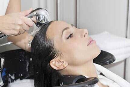 Woman getting hair washed in salon in Lakewood, WA Woman getting hair washed in salon in Lakewood, WA