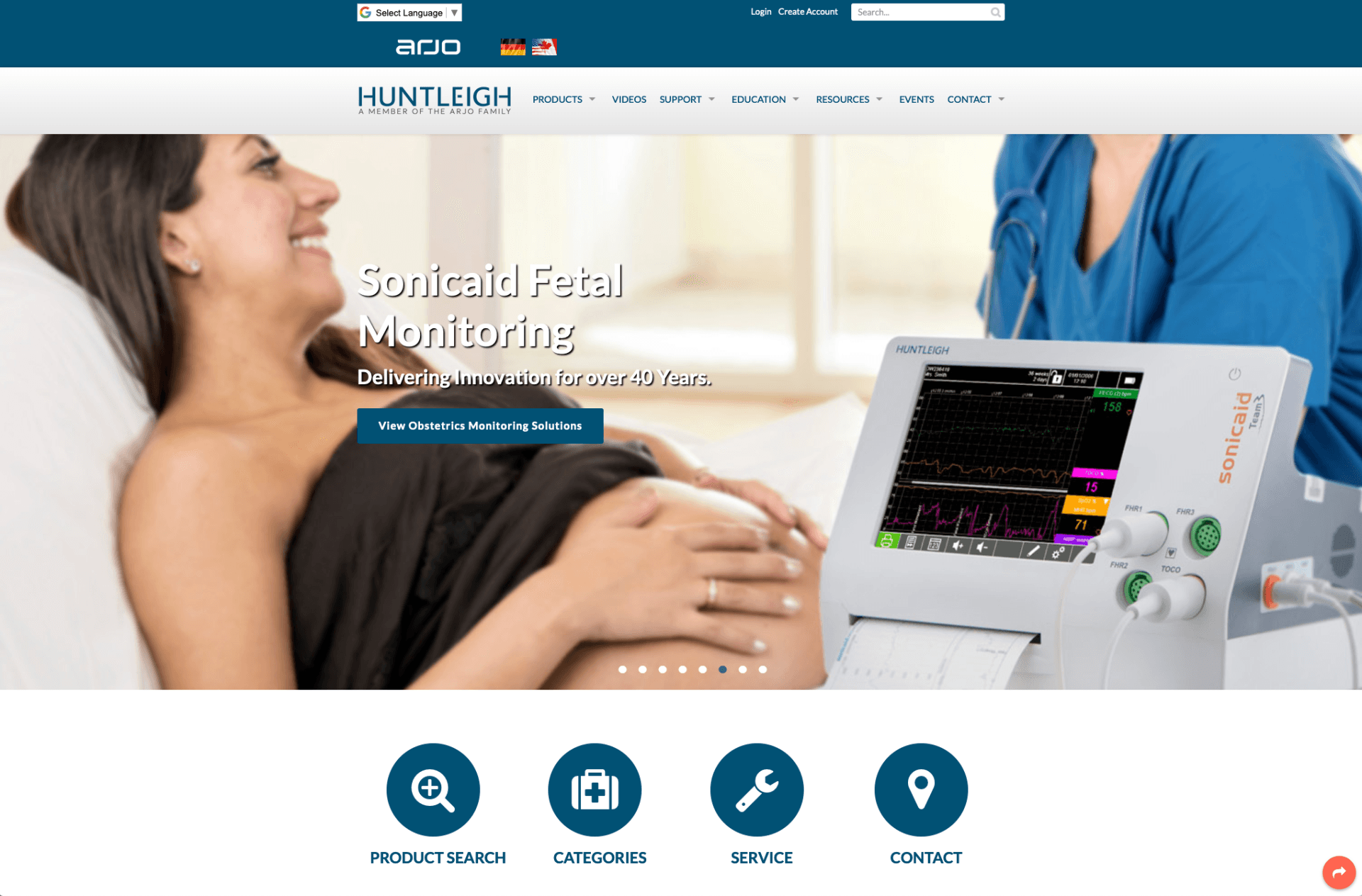 A pregnant woman is laying in a hospital bed next to a monitor