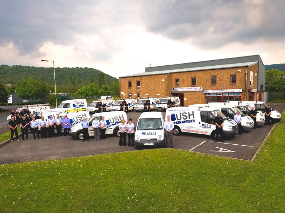 A bunch of bush vans are parked in front of a building