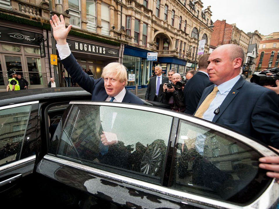 Boris Johnson the then Foreign Secretary visits Newport, South Wales and waves as he gets into his ministerial car before leaving High Street