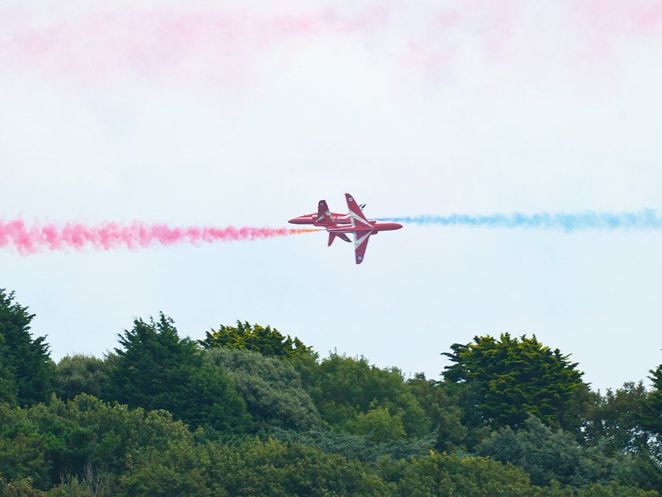 British Red Arrows display team flying across Barry Island, South Wales in close action