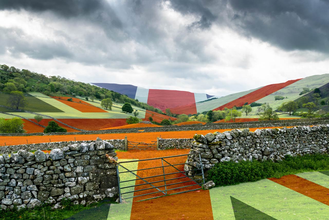 A stone wall surrounds a field with a british flag painted on it