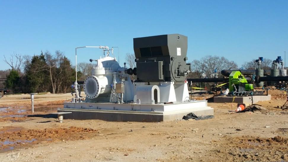 a large machine is sitting in the middle of a dirt field