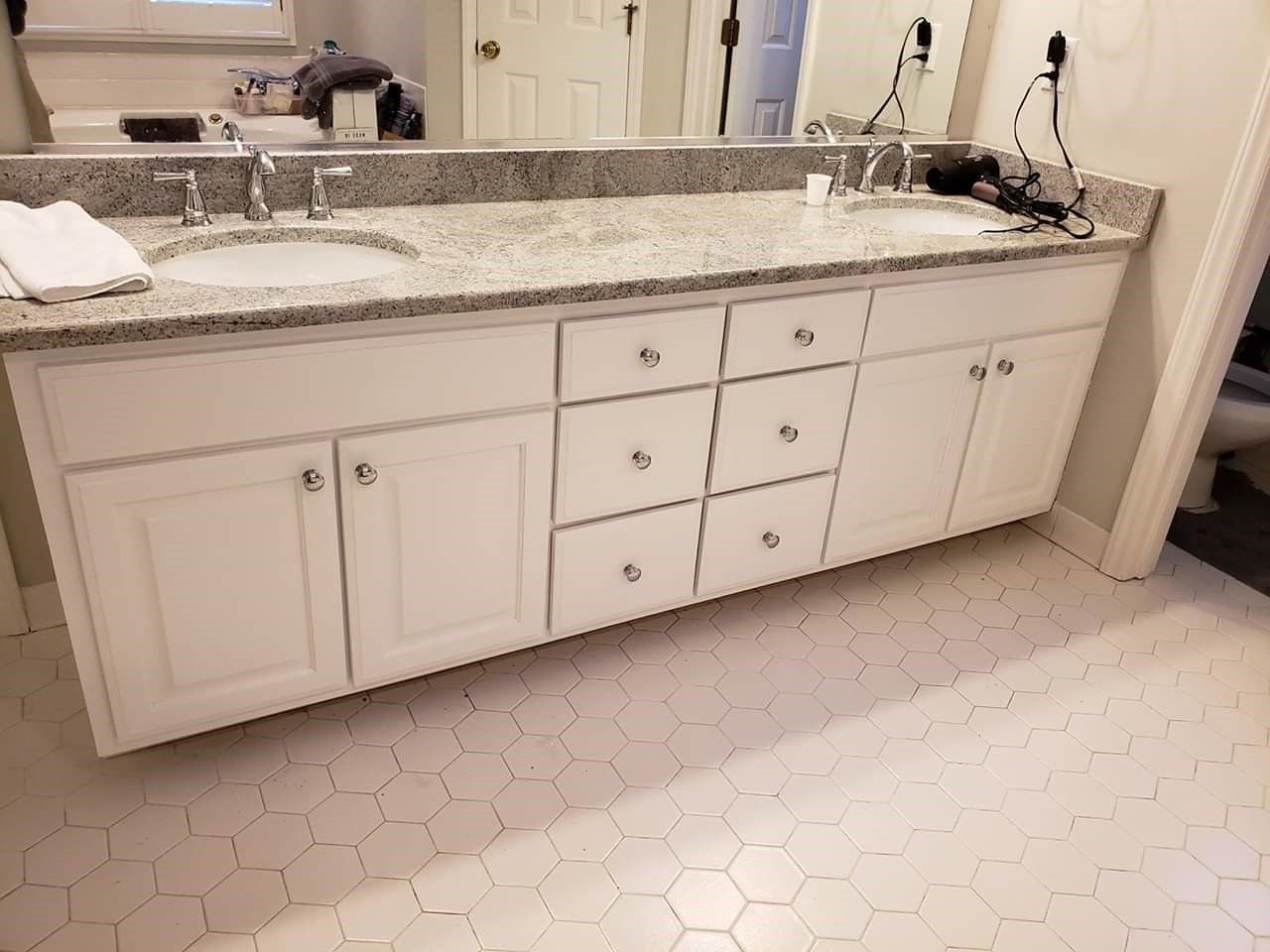 a bathroom with two sinks and a large mirror
