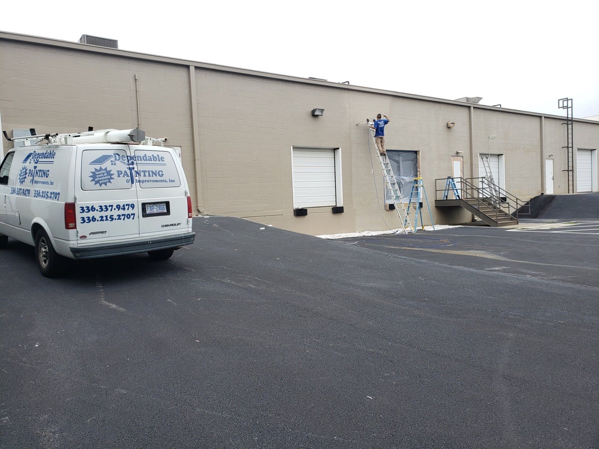 a white van is parked in front of a building