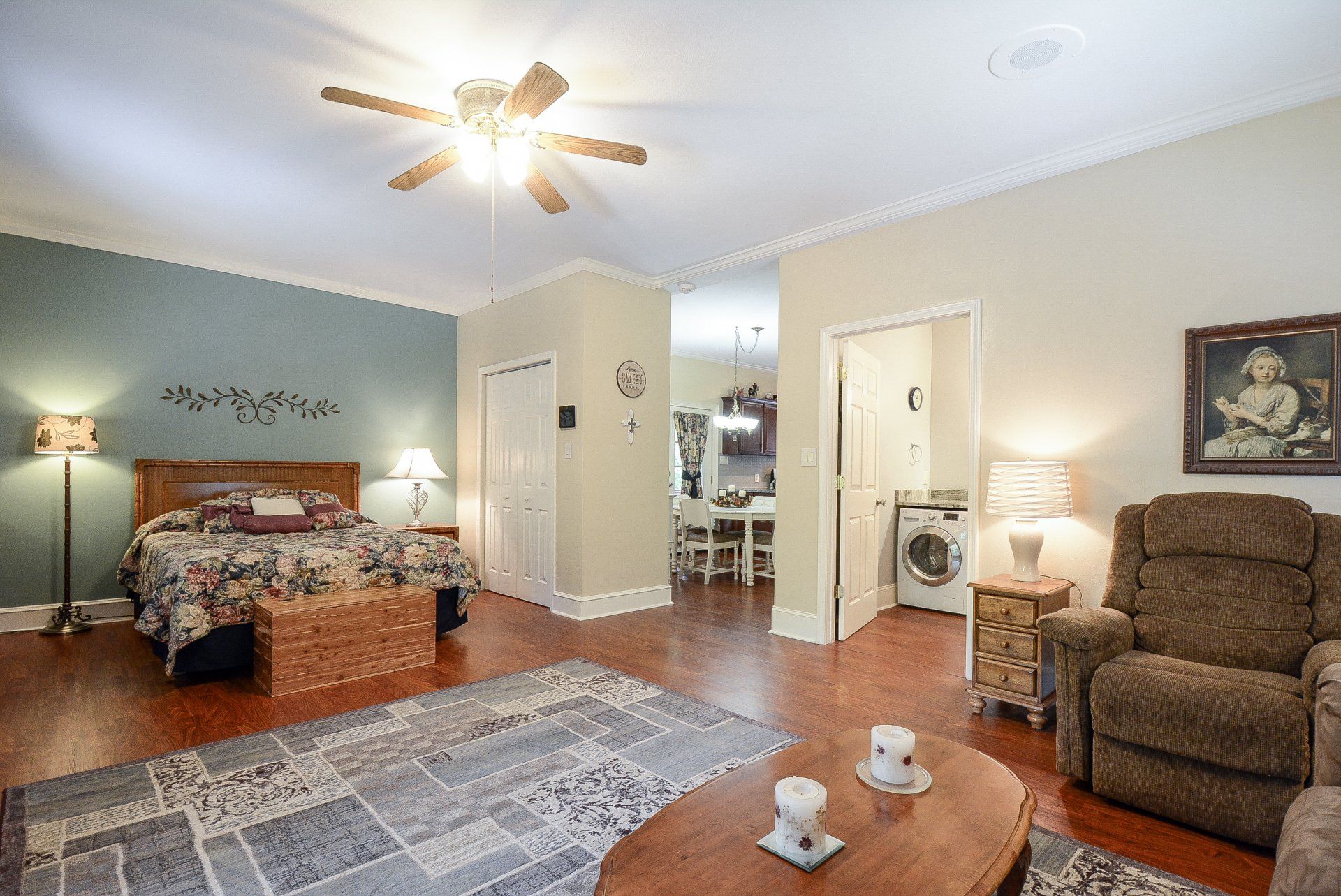 Open-concept studio apartment with bed, living area, and small dining space.