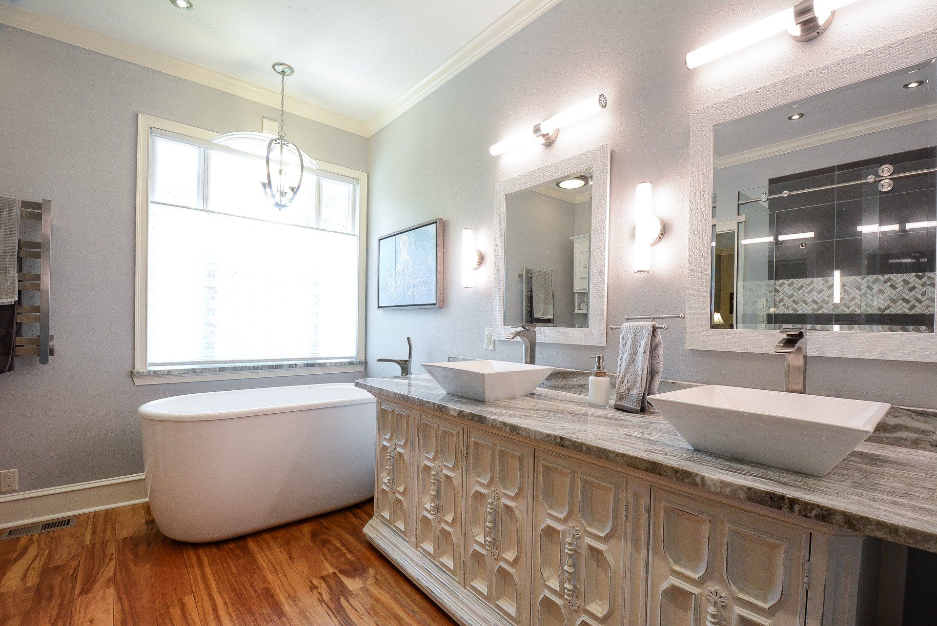 Luxurious bathroom with a soaking tub, double vanity, and window.