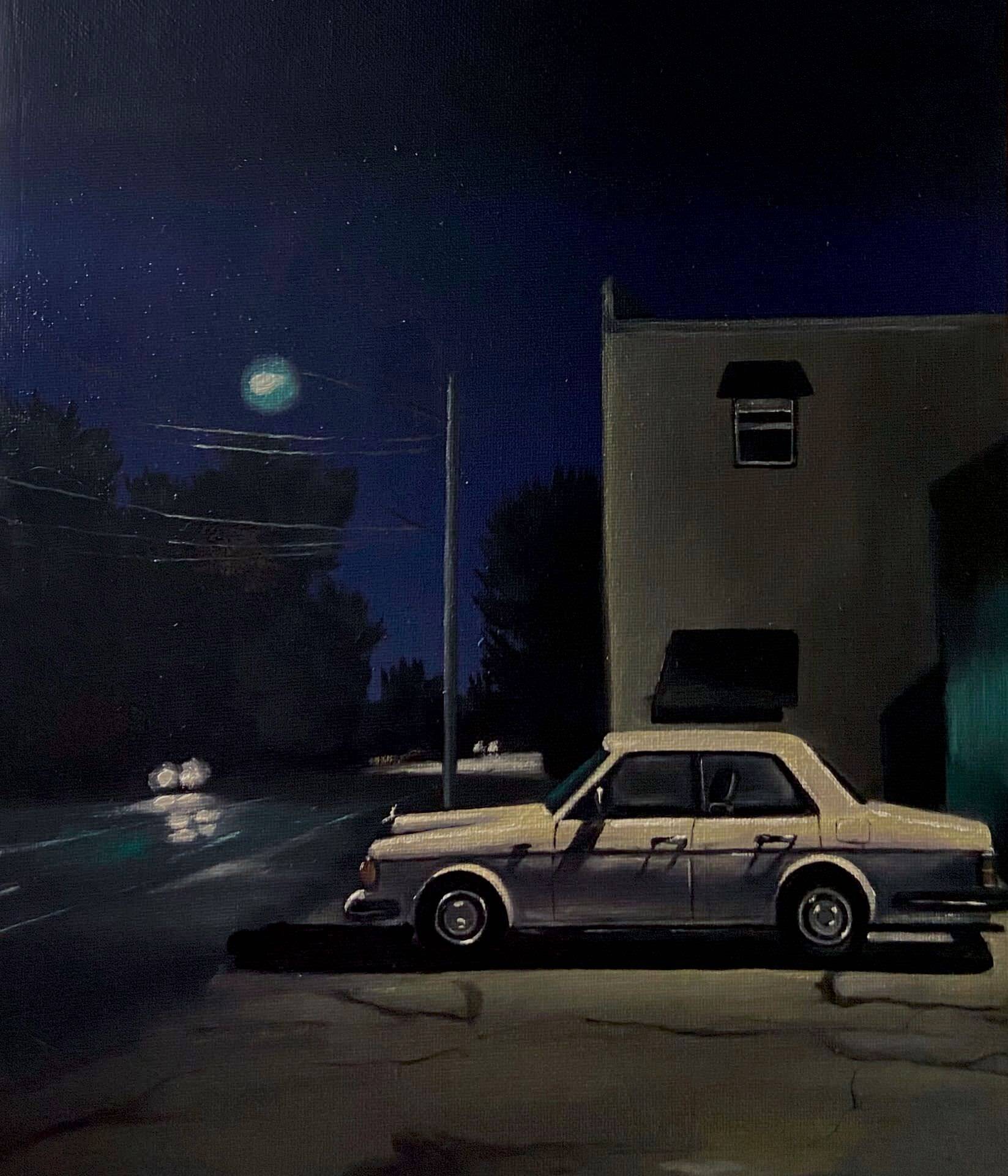 A car is parked in front of a building at night