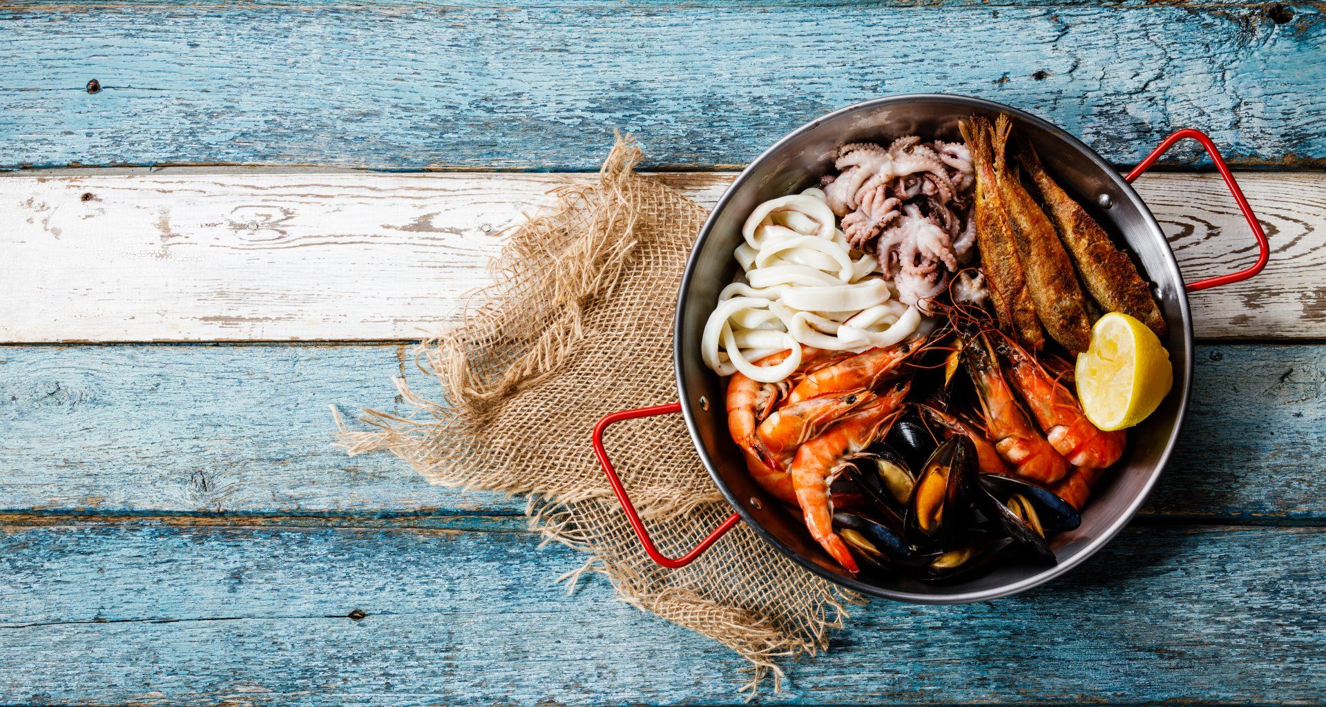 Seafood assorted platter - Prawn Shrimp, Mussels Clams, Squid rings, Octopus mini, roast Mullet copy space