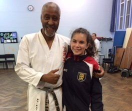 a student with their karate teacher