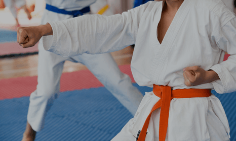 a student wearing orange belt