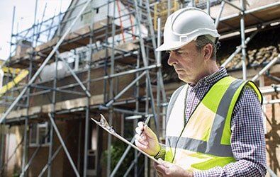 Building Inspector Looking At House Renovation Project — Building Inspection in Plainville, CT