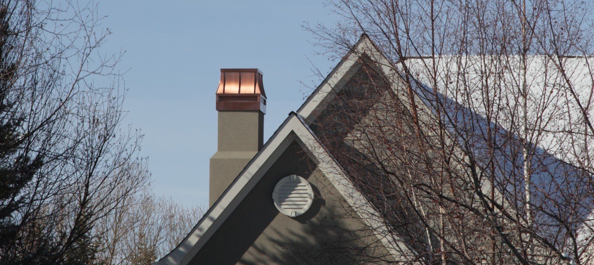 a house with a copper chimney on top of it
