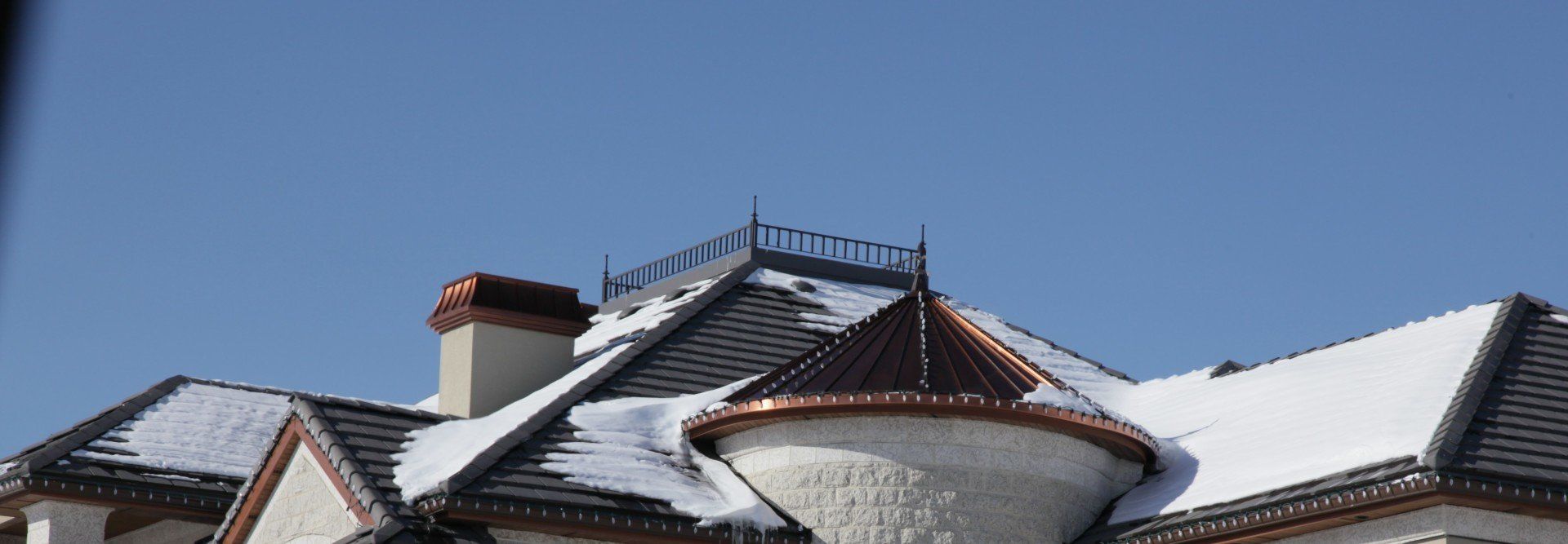 a snowy roof with a balcony on top of it