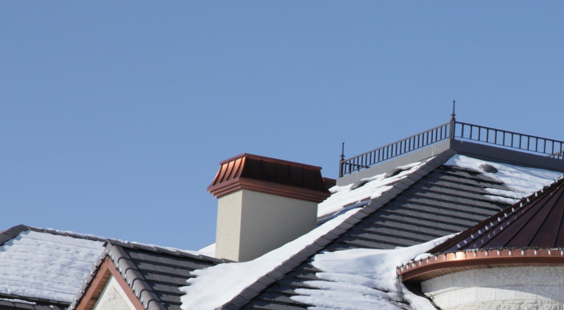 a roof with snow on it and a chimney on top
