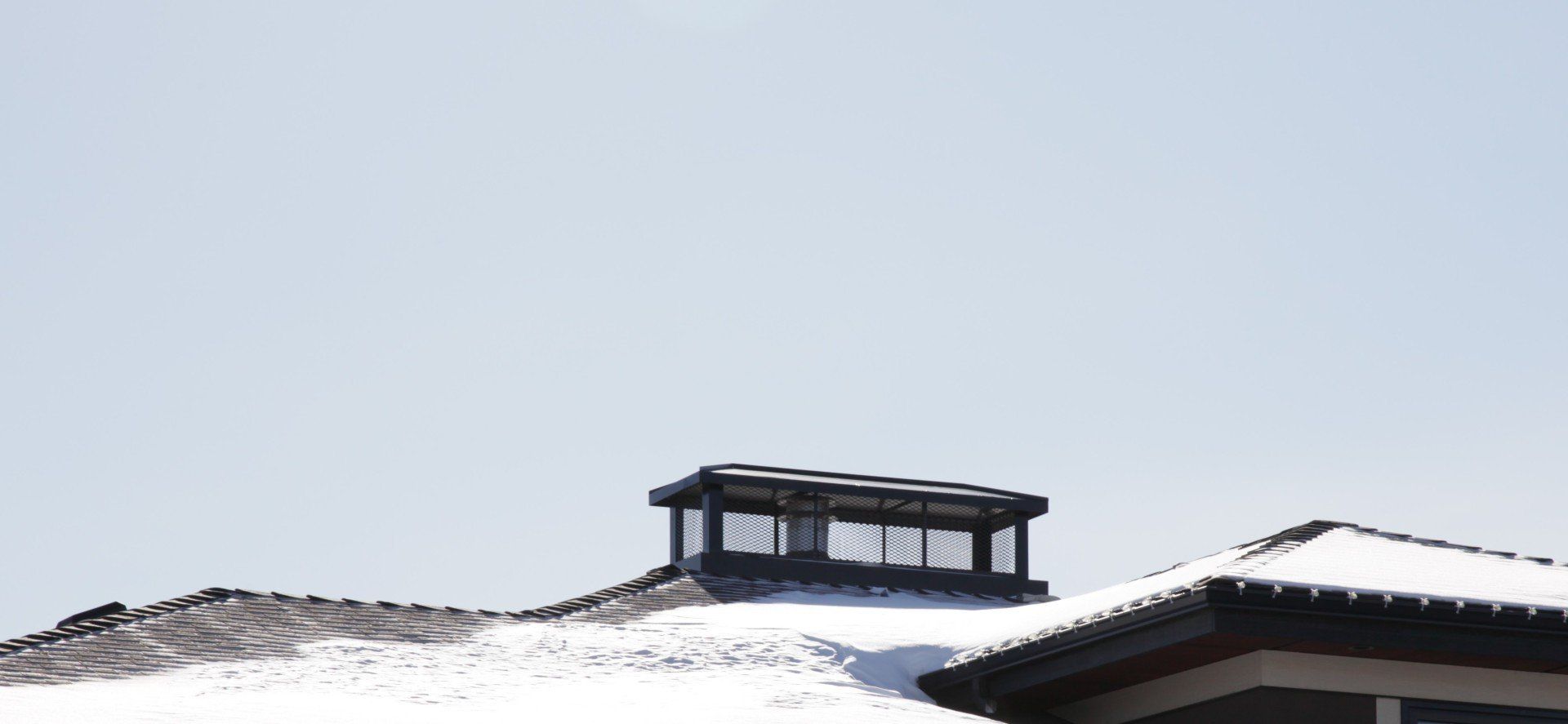 a chimney on top of a snow covered roof