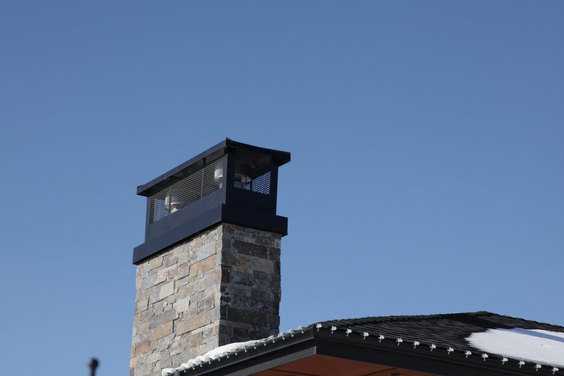 a chimney on top of a house with a blue sky in the background