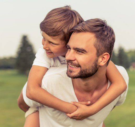 man holding a boy on his back