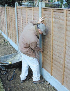Fence with concrete posts being installed