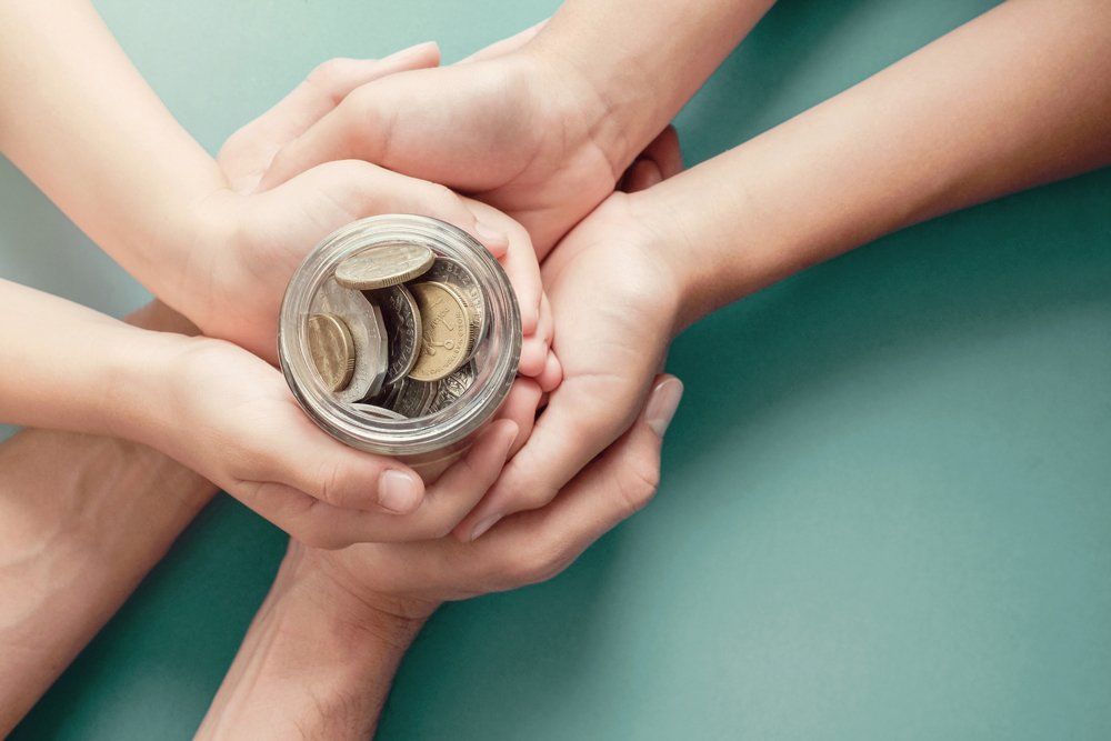 Hands Holding Bottle Of Coins - Financial Support in Orland Park, IL Hands Holding Bottle Of Coins - Financial Support in Orland Park, IL