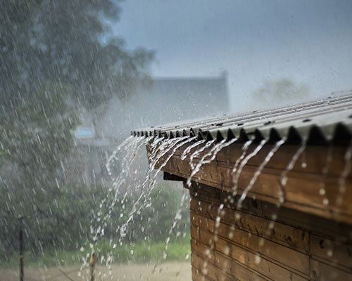 Wind Mitigation — Rain Flows Down from a Roof in Jacksonville, FL