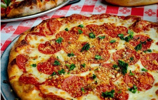 Pizza — Putting Pizza inside the Oven in Baldwin County, LA Pizza — Putting Pizza inside the Oven in Baldwin County, LA