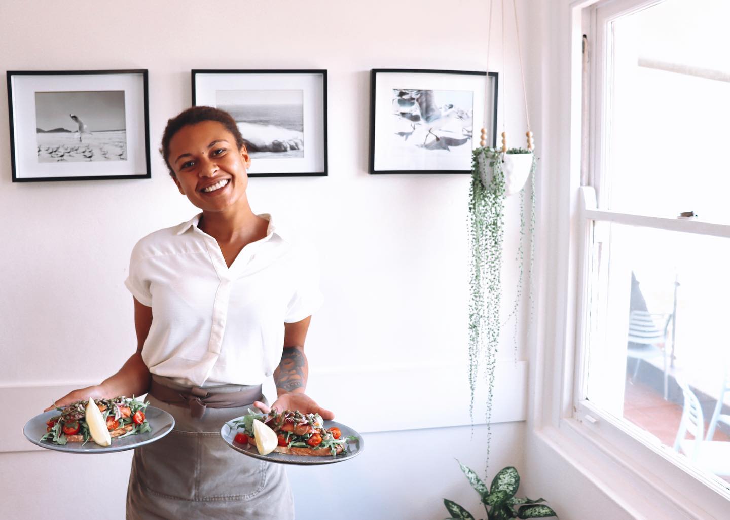Woman Holding A Two Plates With Delicious Food — A Nice Café in Nelson Bay