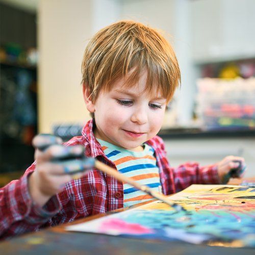 Boy Enjoys Painting — Cheyenne, WY — The Backyard Child Care Center Boy Enjoys Painting — Cheyenne, WY — The Backyard Child Care Center