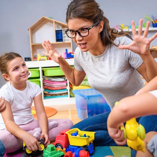 Staff Happy Playing Charades — Cheyenne, WY — The Backyard Child Care Center