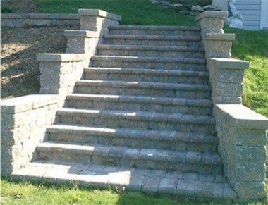 A set of stone stairs leading up to a house.