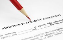 Adoption agreement being signed