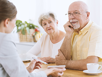 Insurance Agents Near Me — Elderly Couple Talking with Insurance Agent in Mystic, CT